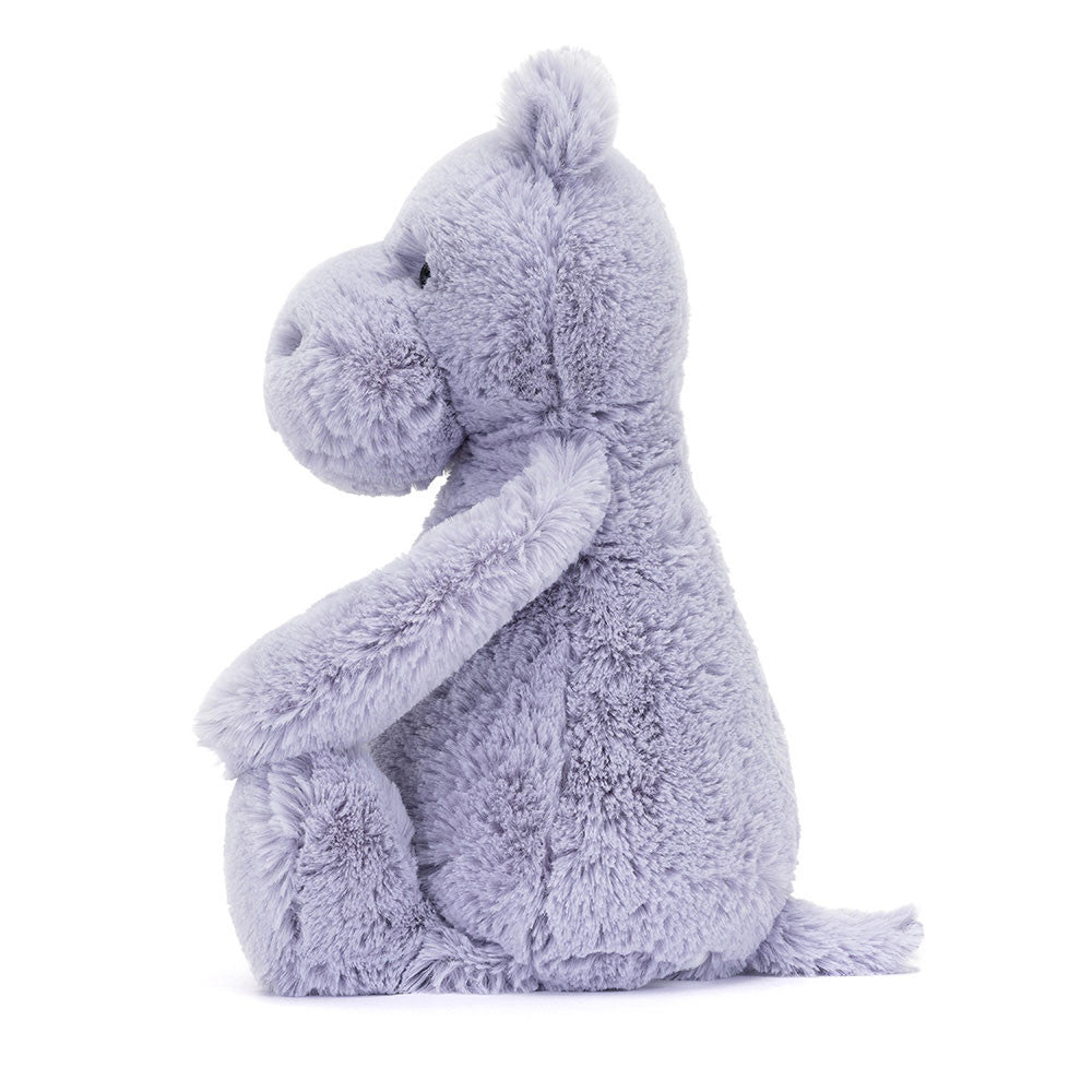 Soft and cuddly plush toy in light lavender color, shaped like a sitting hippo with a gentle expression, called Bashful Hippo, perfect as a toddler gift.