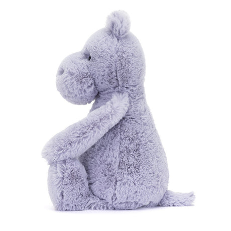 Soft and cuddly plush toy in light lavender color, shaped like a sitting hippo with a gentle expression, called Bashful Hippo, perfect as a toddler gift.