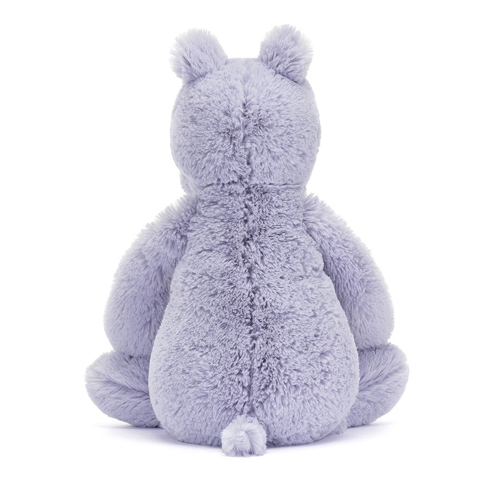 Soft lavender plush stuffed animal shown from the back with rounded ears and a small tail, named Bashful Hippo, designed as a cuddly toddler toy.
