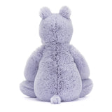 Soft lavender plush stuffed animal shown from the back with rounded ears and a small tail, named Bashful Hippo, designed as a cuddly toddler toy.