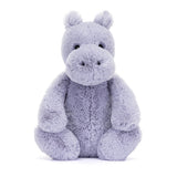 Soft lavender plush toy in the shape of a friendly hippo with round eyes and a large snout, designed as the Bashful Hippo for cuddly comfort and play.
