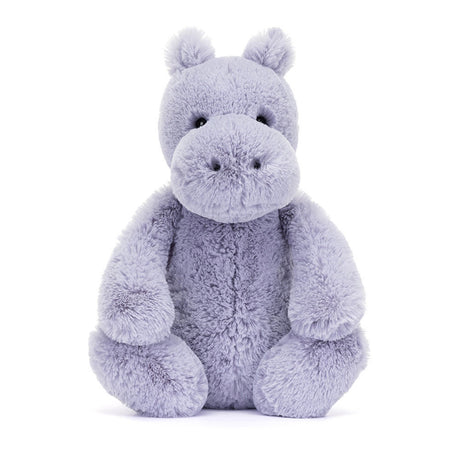 Soft lavender plush toy in the shape of a friendly hippo with round eyes and a large snout, designed as the Bashful Hippo for cuddly comfort and play.