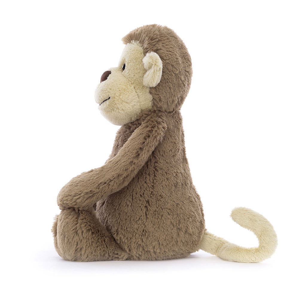 Bashful Monkey Medium plush toy sitting upright with soft brown fur, cream-colored face, ears, and tail, designed as a cuddly stuffed animal for children.