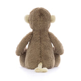 Soft brown plush Bashful Monkey Medium sitting with its back facing forward, showing cream-colored ears and tail, perfect as a toddler toy or stuffed animal gift.