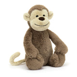 Soft and cuddly Bashful Monkey Medium plush toy with a friendly smiling face, light beige and brown fur, perfect as a child's stuffed animal or toddler toy.