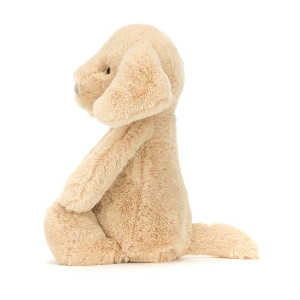 Soft beige plush stuffed dog toy sitting upright with floppy ears and a tail, named Bashful Luxe Puppy Orlando Medium, perfect for toddler toys and kids' birthday gifts.