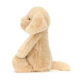 Soft beige plush stuffed dog toy sitting upright with floppy ears and a tail, named Bashful Luxe Puppy Orlando Medium, perfect for toddler toys and kids' birthday gifts.