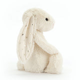 Bashful Twinkle Bunny plush toy sitting upright with soft cream-colored fur and ears decorated with silver star patterns, a perfect cuddly companion for children.