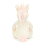 Bashful Unicorn Medium plush toy sitting with its back visible, featuring soft cream fur and light pink mane and tail, perfect as a kid’s birthday gift or stuffed animal.