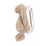 Side view of a soft, plush Bashful Beige Bunny Backpack with long floppy ears and adjustable straps, designed as a cute and cuddly accessory for kids.