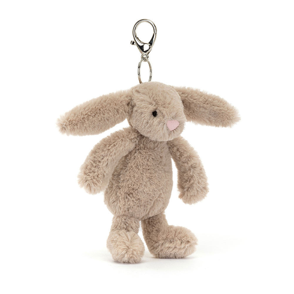 Bashful Beige Bunny Bag Charm with soft plush texture, floppy ears, and a metal clasp for attaching to bags, perfect for adding a cute touch to kids' accessories.