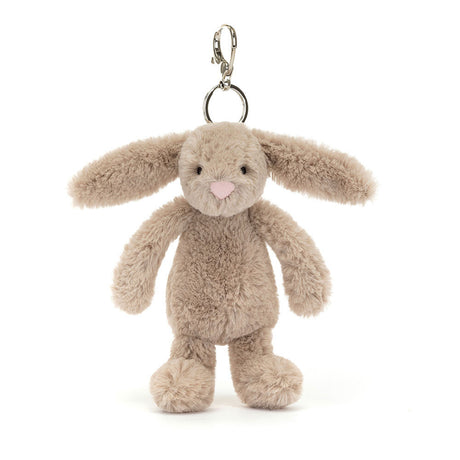 Bashful Beige Bunny Bag Charm is a soft plush beige bunny with long floppy ears, a pink nose, and a silver clasp for attaching to bags or keys.