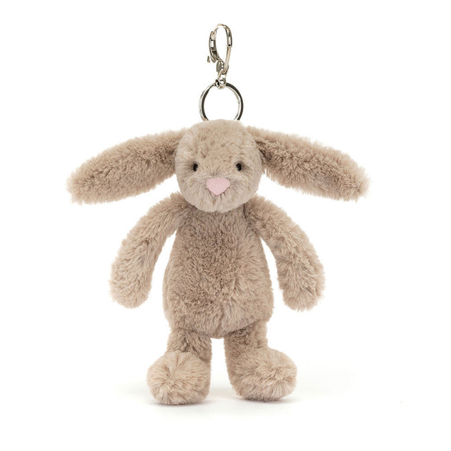 Bashful Beige Bunny Bag Charm is a soft plush beige bunny with long floppy ears, a pink nose, and a silver clasp for attaching to bags or keys.