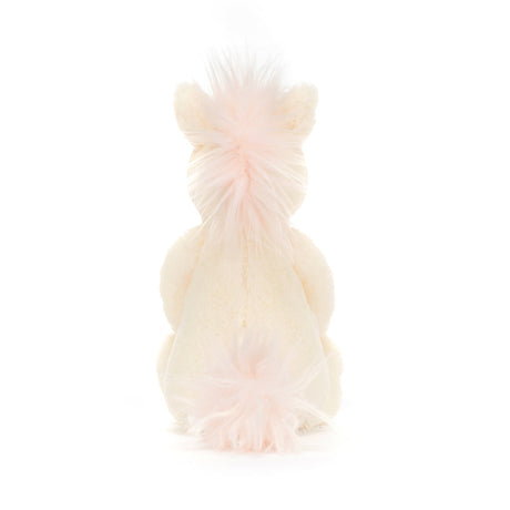 Plush Bashful Unicorn Small toy seen from the back, featuring soft cream-colored fur and light pink fluffy mane and tail, perfect as a toddler toy or stuffed animal.
