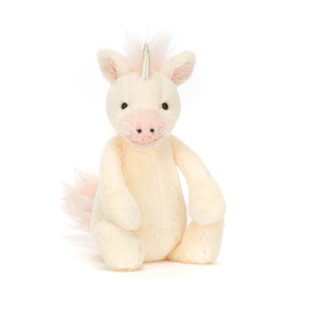 Bashful Unicorn Small is a soft, cream-colored plush unicorn with a pale pink snout, mane, and tail, featuring a shiny silver horn and friendly black eyes.
