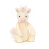 Bashful Unicorn Small is a soft, cream-colored plush unicorn with a pale pink snout, mane, and tail, featuring a shiny silver horn and friendly black eyes.