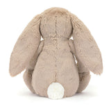 Rear view of a plush Blossom Beige Bunny 'Petal' toy with beige fur and white tail on a white background