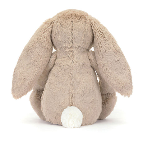 Rear view of a plush Blossom Beige Bunny 'Petal' toy with beige fur and white tail on a white background