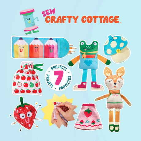 Sew Crafty Cottage sewing kit cover featuring colorful fabric doll and sewing-themed designs on a light blue background, including a frog doll, rabbit doll, strawberry patch, pencil case, mushroom hat, and a hand demonstrating sewing.