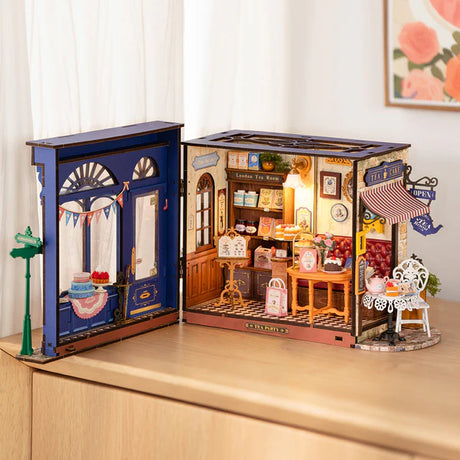 Miniature model of Leisure Time Tea Room inside a wooden cabinet with detailed interior.