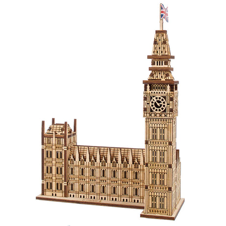 Wooden model of the Big Ben clock tower with a British flag on top, on a white background.