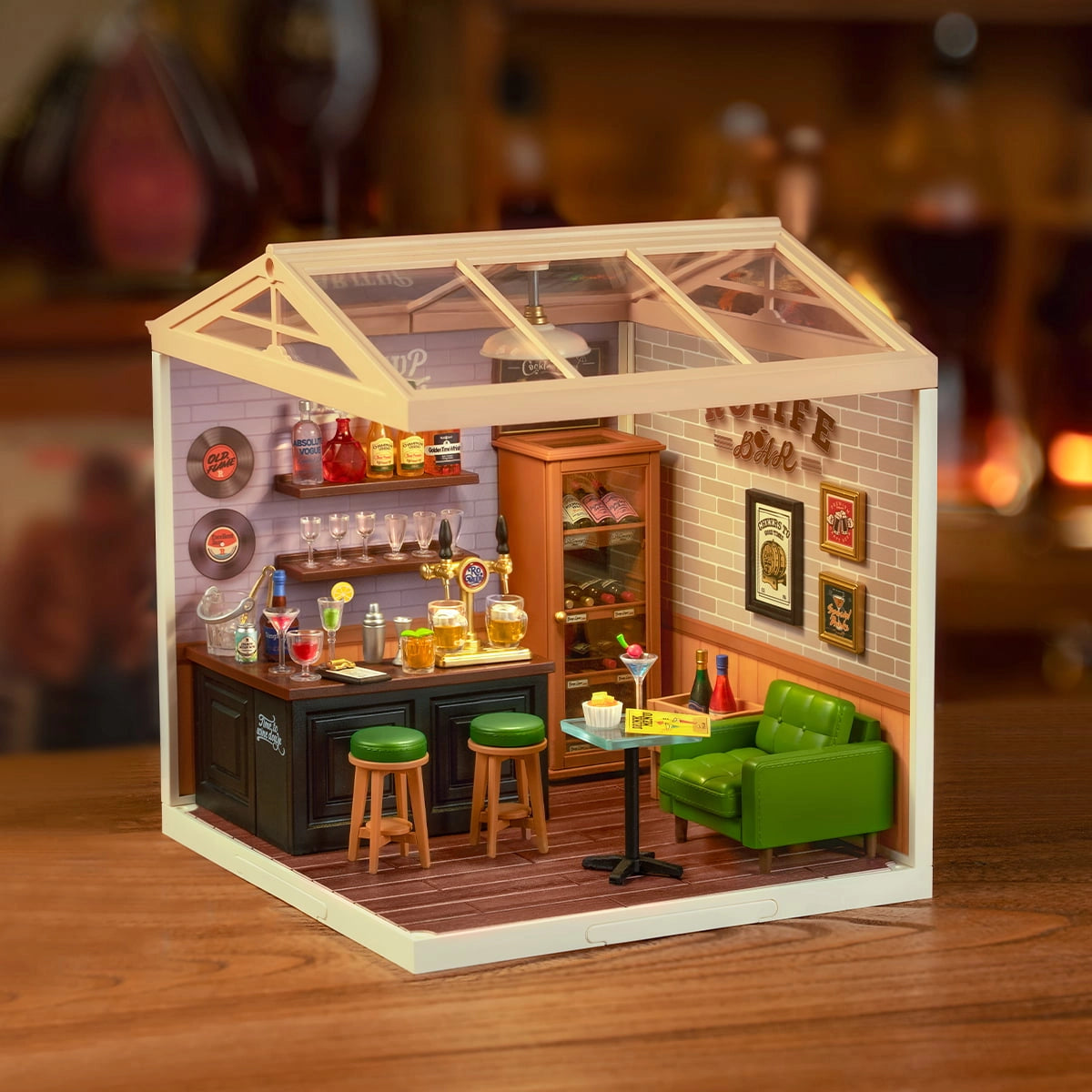 Miniature model of a Leisurely Cheers Bar with furniture and decor on a wooden surface.