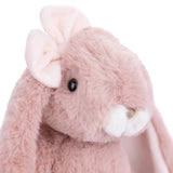 Close-up of a pink plush Friendly Kanina - Antique Pink bunny with a white bow on a white background