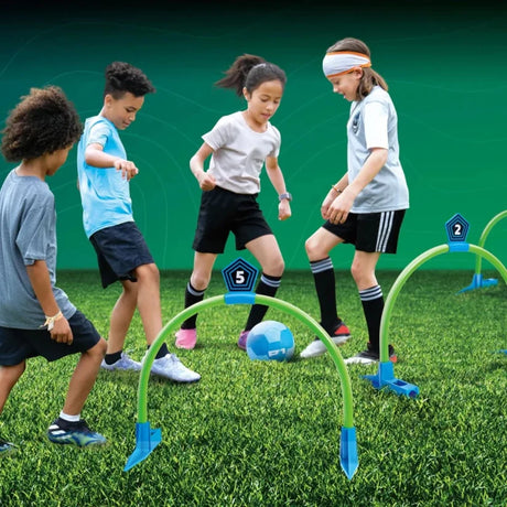 Children playing with Kick Croquet Strike on grass