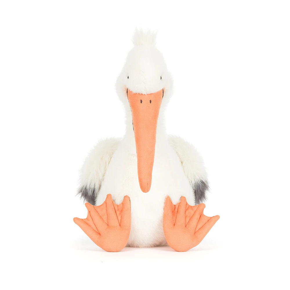 Soft plush Keli Pelican toy with a long orange beak, fluffy white body, gray wing tips, and large orange webbed feet, perfect for kids' imaginative play.