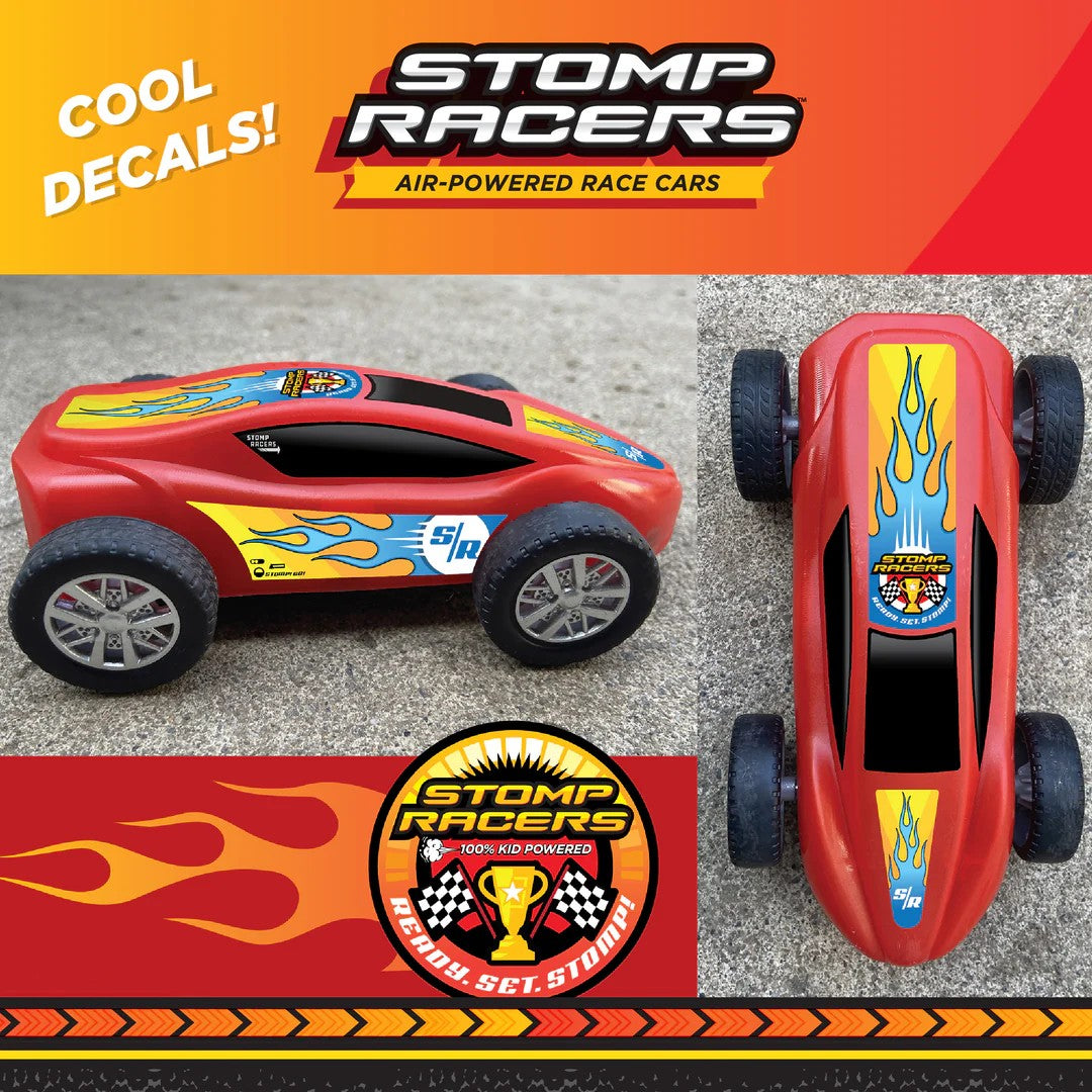 Red toy race cars with flame design on a gray surface, featuring 'Stomp Racers' branding.