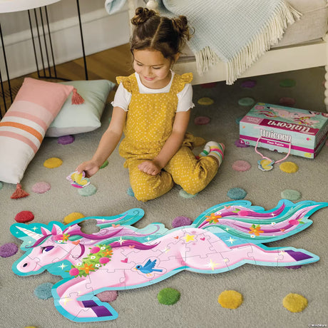 Child playing with a Shimmery Unicorn Floor Puzzle on the floor in a livingroom setting.