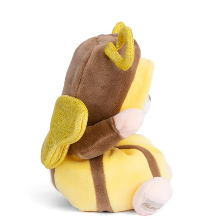 Plush toy bear in a yellow butterfly costume on a white background