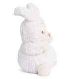 Plush toy bear dressed as a rabbit in a white outfit on a white background