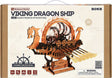 Box of a Viking Dragon Ship model kit by ROKR with wooden ship illustration on beige background