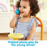 Child playing with a toy phone and steering wheel, with text 'Pretend phone play for the young driver!'.