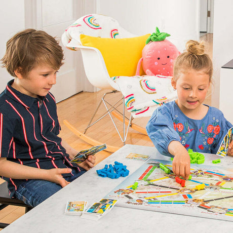 Two children playing Ticket to Ride: First Journey at a table.