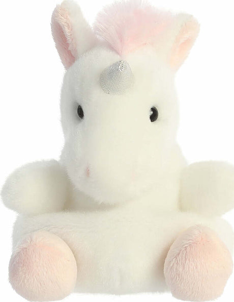 Plush unicorn toy with pastel colors on a white background