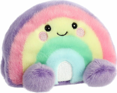Pastel rainbow-shaped plush toy with a smiling face on a white background