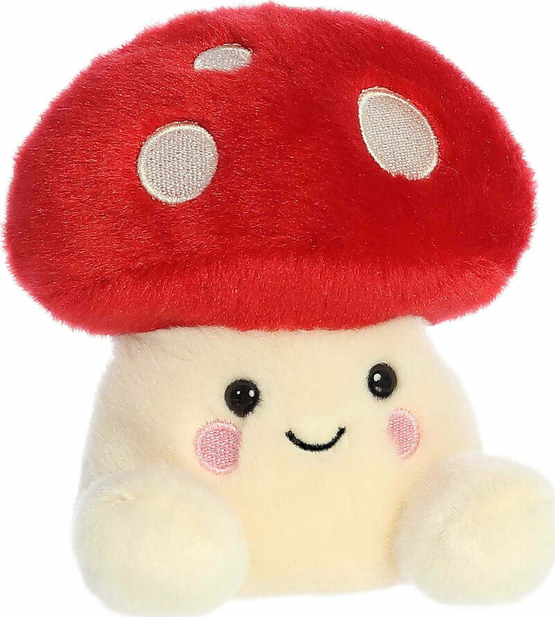 Plush toy mushroom with a red cap and smiling face on a white background
