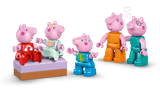 Five pink toy pigs in colorful outfits on a green background