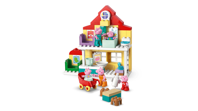 Toy  Family House  set with various furniture pieces on a green background