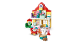 Toy  Family House  set with various furniture pieces on a green background
