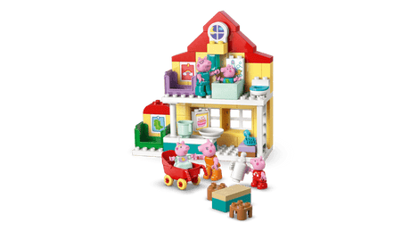 Toy  Family House  set with various furniture pieces on a green background