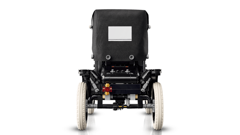 Back view of a black LEGO  Ford Model T on a green background