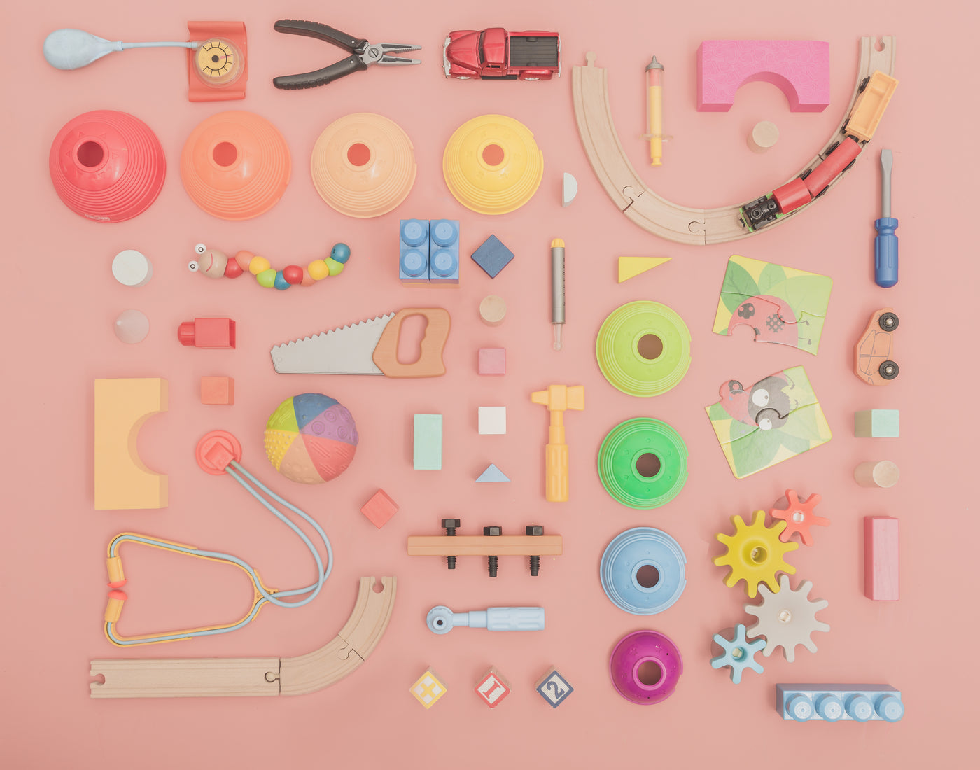 Grid of assorted toys with rainbow colors theme.