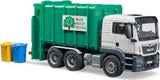 Man Tgs Rear Loading Garbage Truck with a green container and 'Reuse Reduce Recycle' sign, next to yellow and blue trash bins on a white background.