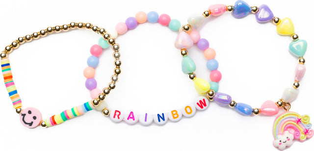 Colorful beaded Rainbow Smiles Bracelet Set with rainbow letters and a rainbow charm on a white background