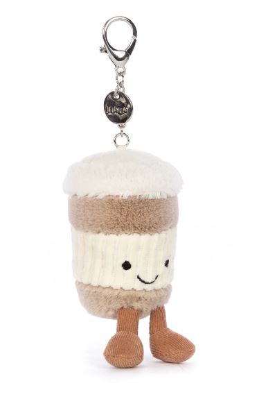 Soft plush keychain shaped like a smiling coffee cup with legs, featuring warm beige and cream colors and a metal clip, called Coffee-To-Go Charm Amuseables.