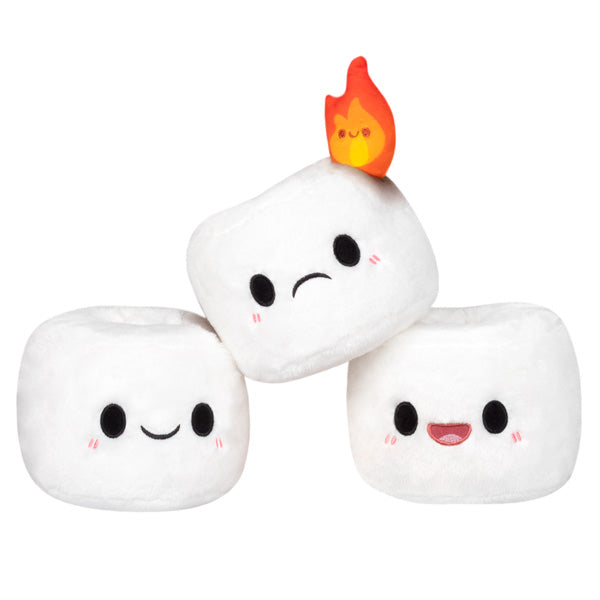 Three soft Mini Comfort Food Marshmallows plush toys with cute faces, one featuring a small flame on top, displayed on a white background.