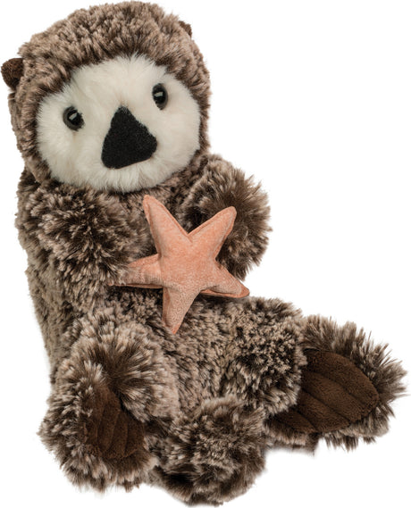 Plush Cruz Sea Otter holding a starfish on a white background